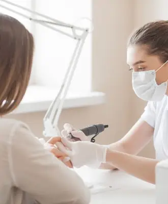 ae7ad427 manicurist making manicure salon master servising her client nails care procedure 1 min.jpg